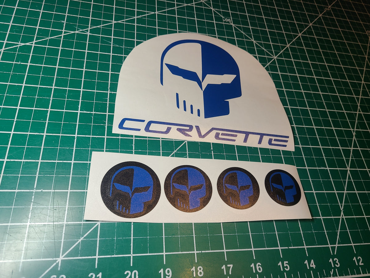 C6 CORVETTE RACING "JAKE" SKULL ENGINE BAY OVERLAYS FOR POWER STEERING, OIL, RADIATOR OVERFLOW, BRAKE FLUID CAPS, & fuse panel cover.